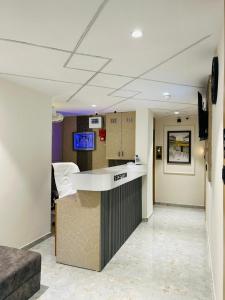 a lobby of a hospital with a reception counter at Hotel sun town in Ahmedabad