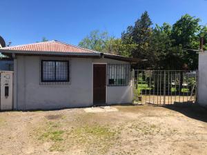 a small house with a gate and a fence at Talca-Maule in Talca