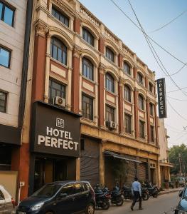 a hotel with motorcycles parked in front of a building at Hotel Perfect, Karol Bagh, 2 mins walk from metro station in New Delhi