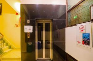 a hallway with a elevator in a building at Hotel Perfect, Karol Bagh, 2 mins walk from metro station in New Delhi +3 photos