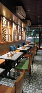 a dining room with tables and chairs in a restaurant at SriKrishna Paradise Hotel Thane Navi Mumbai in Thane