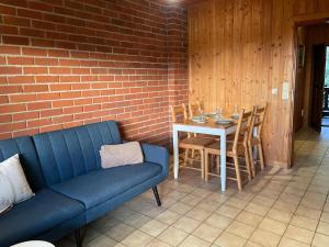 a living room with a couch and a table at Modernes Top Apartment mitten im Bayerischen Wald + WLAN kostenfrei in Schöfweg