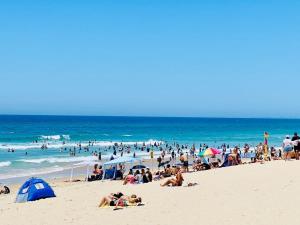 a large group of people on a beach at L20 High Apt 2 Beds in Gold Coast