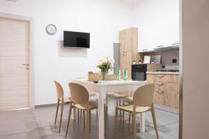 a kitchen with a white table and chairs at Micky House in San Marzano sul Sarno