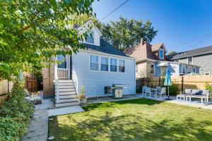 a white house with a fence and a yard at Logan Square Urban Oasis: 2 Mi to Local Hotspots! in Chicago