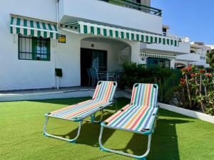 two chairs sitting on a lawn in front of a house at Vista Dorada in Sonnenland