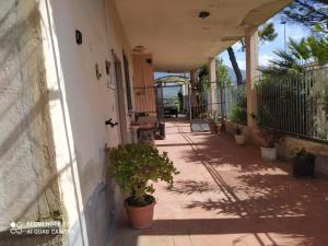 a porch of a house with potted plants on it at PM 698 Via Fuscillo in Mattine