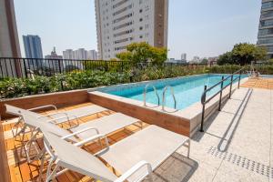 a swimming pool with lounge chairs next to a building at Maison Perdizes - Allianz Parque Supreme in Sao Paulo +80 photos