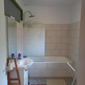a bathroom with a tub and a sink at La Gisière, Chambres d'hôtes in Challans