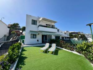 two chairs on a lawn in front of a house at Vista Dorada in Sonnenland