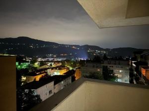 a view of a city at night from a balcony at Luxury Heaven Vogošća in Vogošća