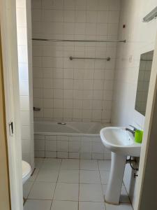 a bathroom with a sink and a tub and a toilet at MableHomestay in Mzuzu