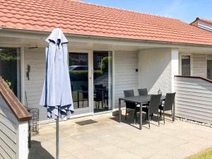 a patio with a table and a white umbrella at 4 person holiday home in Ærøskøbing-By Traum in Ærøskøbing +30 photos