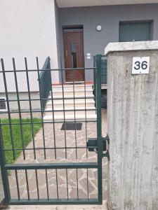 a gate in front of a house with a sign on it at Casa Nico in Dossobuono