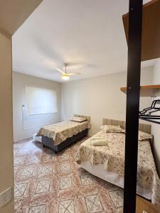 a bedroom with two beds and a ceiling at Apartamento no centro de Aparecida in Aparecida