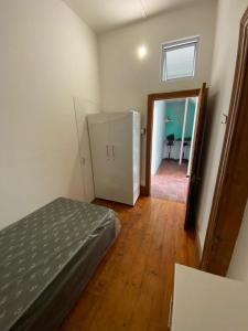 a bedroom with a bed and a door to a dining room at House Grace in Gqeberha +10 photos