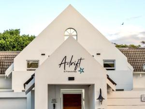 a white church with a pointed roof at Adrift Guesthouse in St Francis Bay