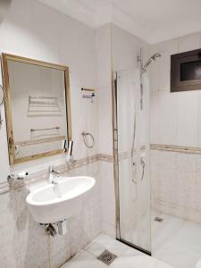 a bathroom with a sink and a shower at Burj Al Hayat Furnished Apartment - Jazan in Jazan