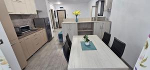 a kitchen with a table and chairs in a room at Beach Pool & Spa Resort Mamaia Nord Alezzi piscina incalzita in Mamaia Nord