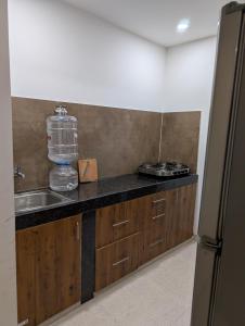 a kitchen with a sink and a counter top with a counter top at Cozy 2-Bedroom Flat with Wi-Fi & AC in Hyderabad