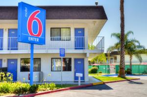 un edificio con una señal de entrada delante de él en Motel 6-Santa Nella, CA - Los Banos - Interstate 5, en Santa Nella