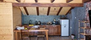 a kitchen with wooden cabinets and a white refrigerator at Galash-R in Mestia