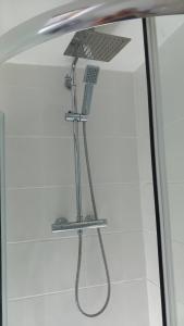 a shower in a bathroom with a shower head at Longhurst House Annexe in Staplehurst +18 photos