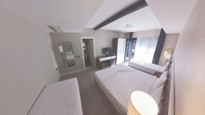a hospital room with a bed and a mirror at Lulubay Rooms & Suites in Kuşadası
