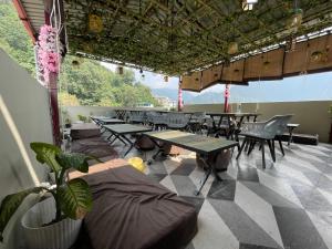 a group of tables and chairs in a room at Yatram in Rishīkesh