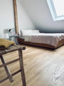 a bedroom with a bed and a wooden floor at Dr. Bockemüller Appartements in Sickte
