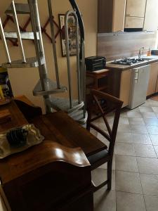 a kitchen with a wooden table and a refrigerator at GEAs in Casale Monferrato