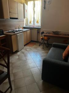 a kitchen with a couch and a kitchen with a table at GEAs in Casale Monferrato