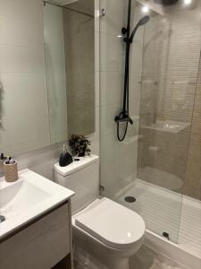 a bathroom with a shower and a toilet and a sink at Pucón Infinity Camino al Volcán in Pucón +12 photos