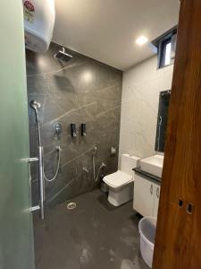 a bathroom with a shower and a toilet at Yatram in Rishīkesh +16 photos
