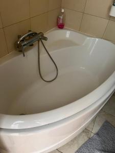 a bath tub with a faucet in a bathroom at Niedras place in Degole