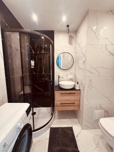 a bathroom with a shower and a sink at Black or White Świdnik Apartment's in Świdnik