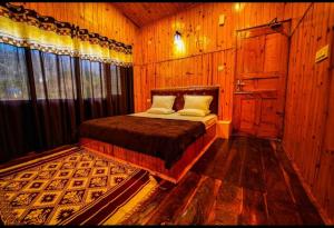 A bed or beds in a room at Chiranjeevi Slopey hill resort