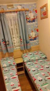 a bedroom with a bed and a window with sailboats on it at The grange caravan park ingoldmells in Addlethorpe