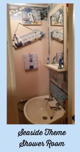 a bathroom with a sink and a mirror at The grange caravan park ingoldmells in Addlethorpe +11 photos