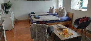 a room with two beds and a table in a room at Lunitz 19 in Görlitz