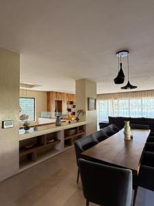 a living room with a dining table and a kitchen at La source d'argan golf villa proche du centre in Marrakech