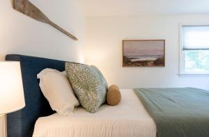 a bedroom with a bed with a pillow on it at Beachwood of Narragansett in Narragansett