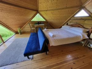 a large bed in a room in a wooden house at Sauna, Hot Tub & Cold Plunge Pyramid Escape in Lindridge