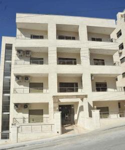 a large white building with a lot of windows at Villa Amman in Al Jafr