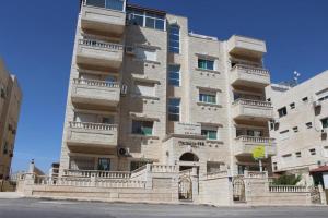 a large brick building with balconies on the side of it at Villa Amman in Al Jafr