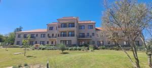 a large house with a yard in front of it at Apart entre viñas in Cafayate