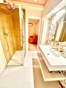 a bathroom with a sink and a shower at Doria Suite in Patti