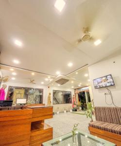 a living room with a piano and a couch at Hotel The Golden Bird in Agra