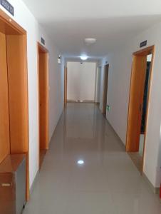 a hallway of an office building with a long corridor at Auberge de la lecture in Djibouti
