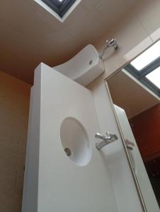 a bathroom with a sink and a mirror at Auberge de la lecture in Djibouti +5 photos